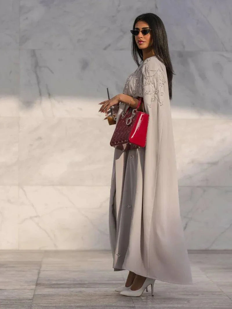 Light gray quartz cape-style abaya with tonal embroidery, open front, and flowy crepe fabric perfect for elegant layering