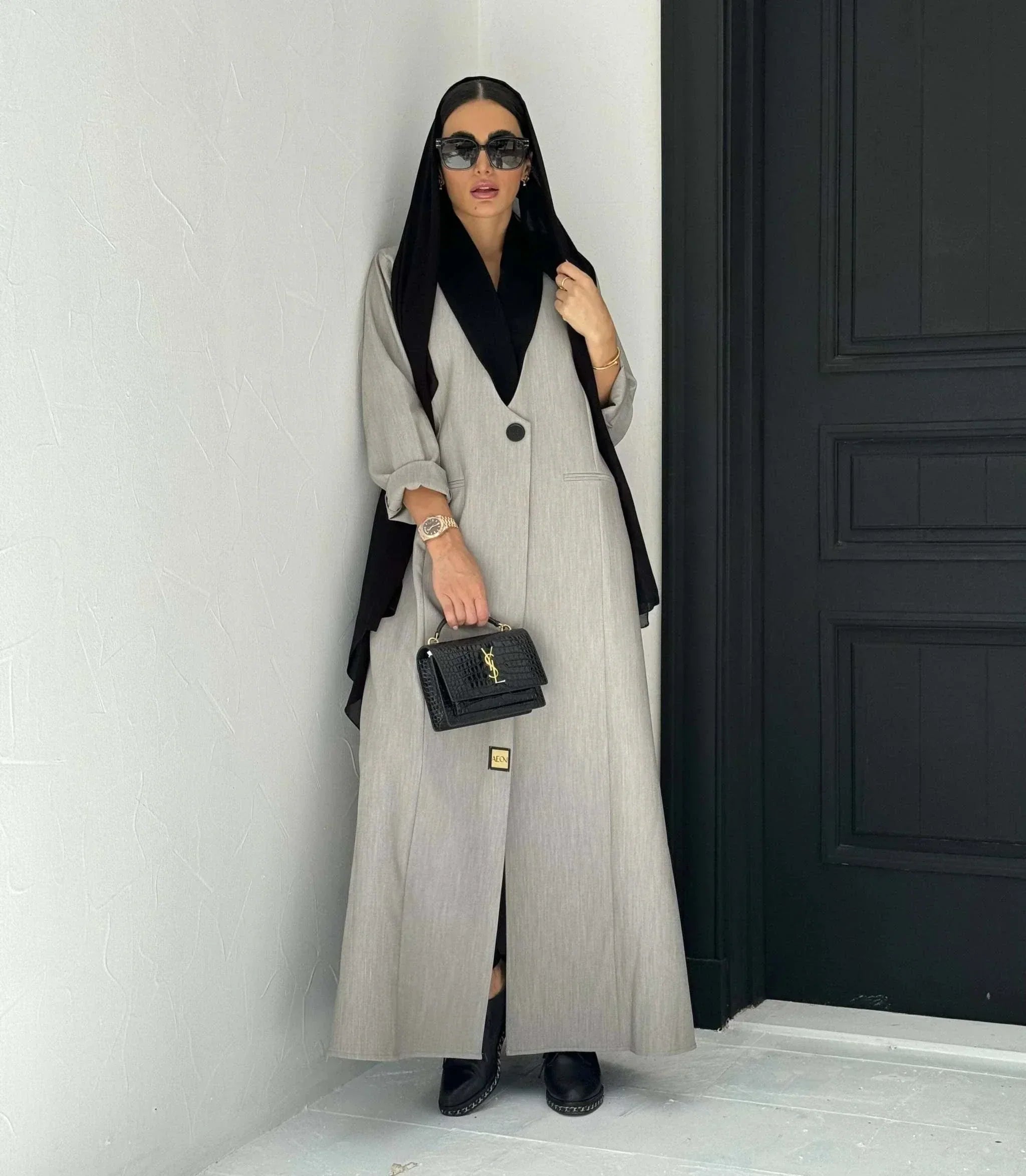 Modern gray crepe abaya with black collar, single button, and relaxed sleeves, styled with black hijab and handbag - Shadow Blend
