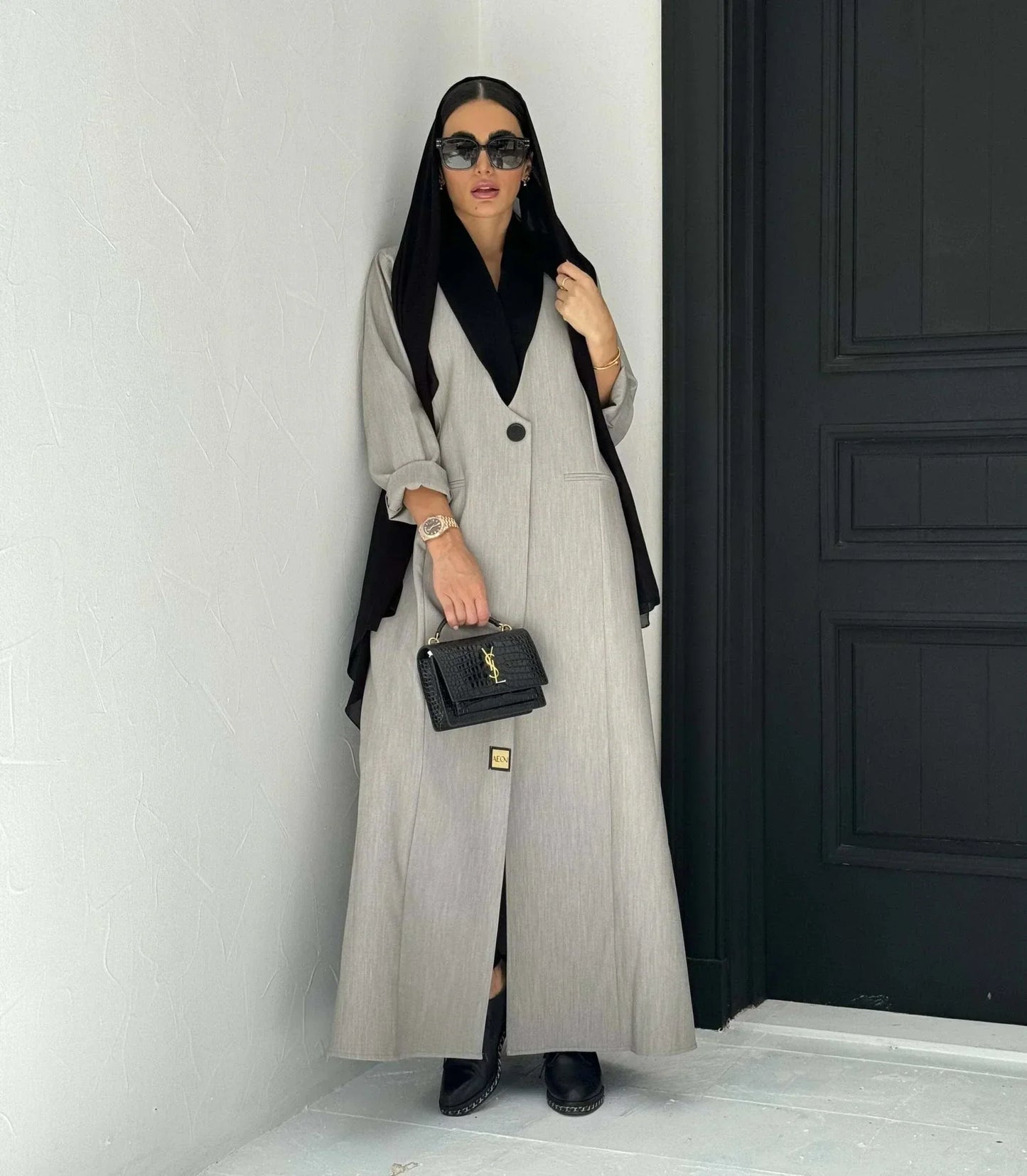 Modern gray crepe abaya with black collar, single button, and relaxed sleeves, styled with black hijab and handbag - Shadow Blend