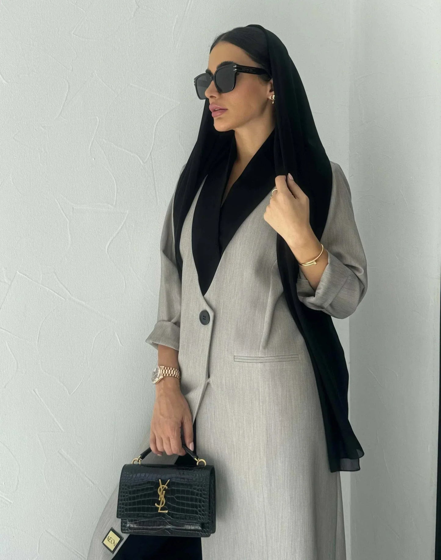 Modern gray crepe abaya with black collar, single button, and relaxed sleeves, styled with black hijab and handbag - Shadow Blend