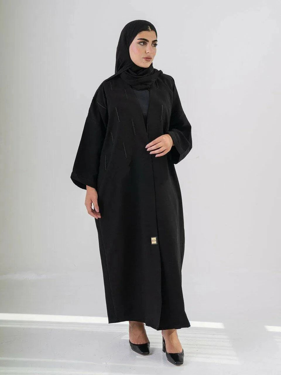 Elegant black abaya with subtle front embroidery, made from high-quality crepe for year-round comfort and versatile wear
