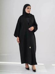 Elegant black abaya with subtle front embroidery, made from high-quality crepe for year-round comfort and versatile wear