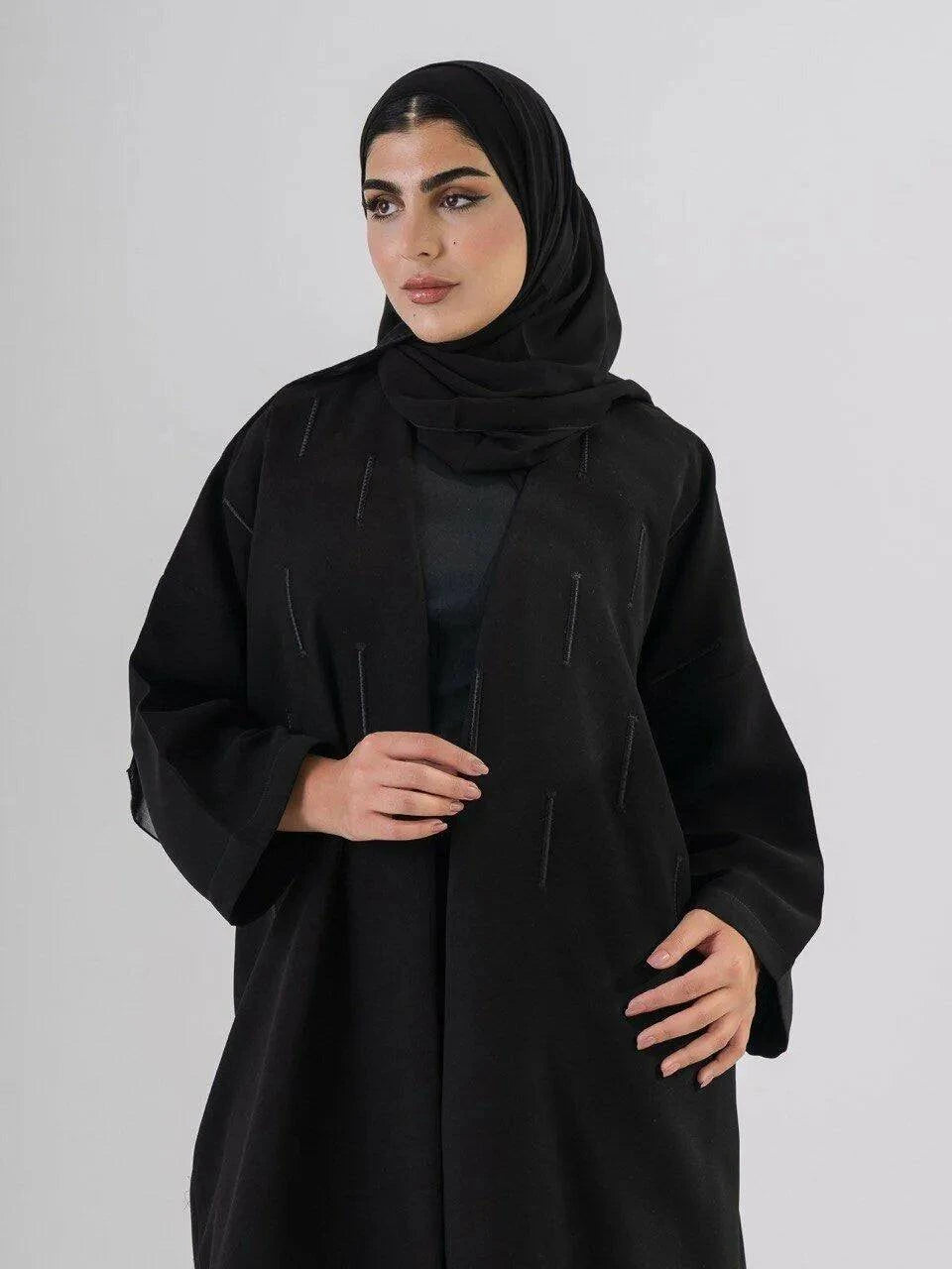 Elegant black abaya with subtle front embroidery, made from high-quality crepe for year-round comfort and versatile wear