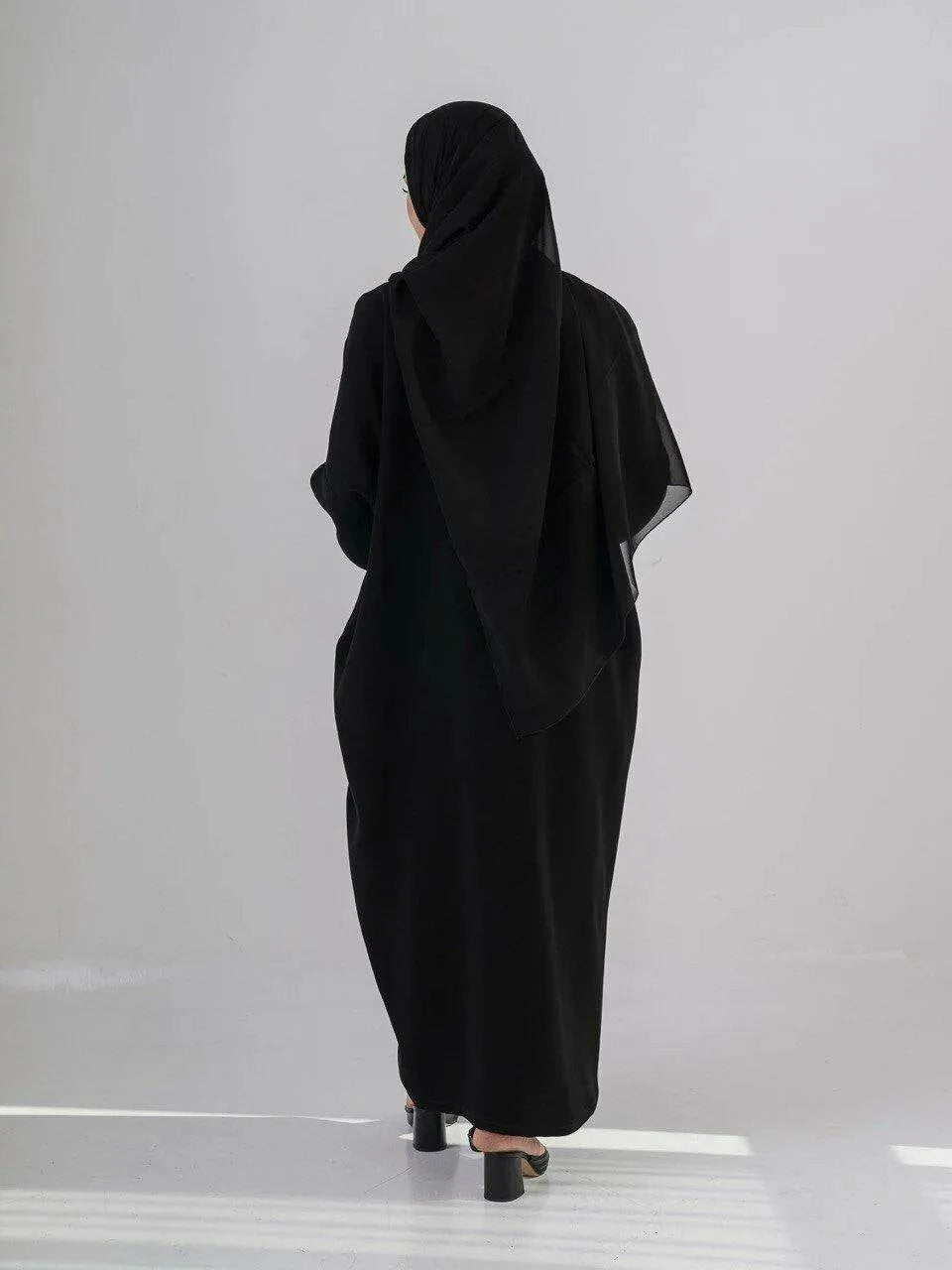 Elegant black abaya with subtle front embroidery, made from high-quality crepe for year-round comfort and versatile wear