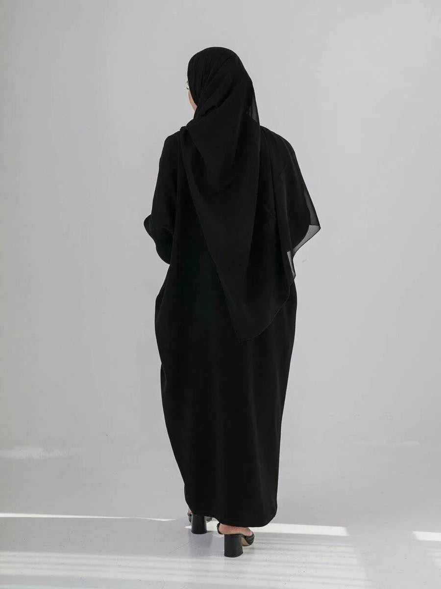 Elegant black abaya with subtle front embroidery, made from high-quality crepe for year-round comfort and versatile wear