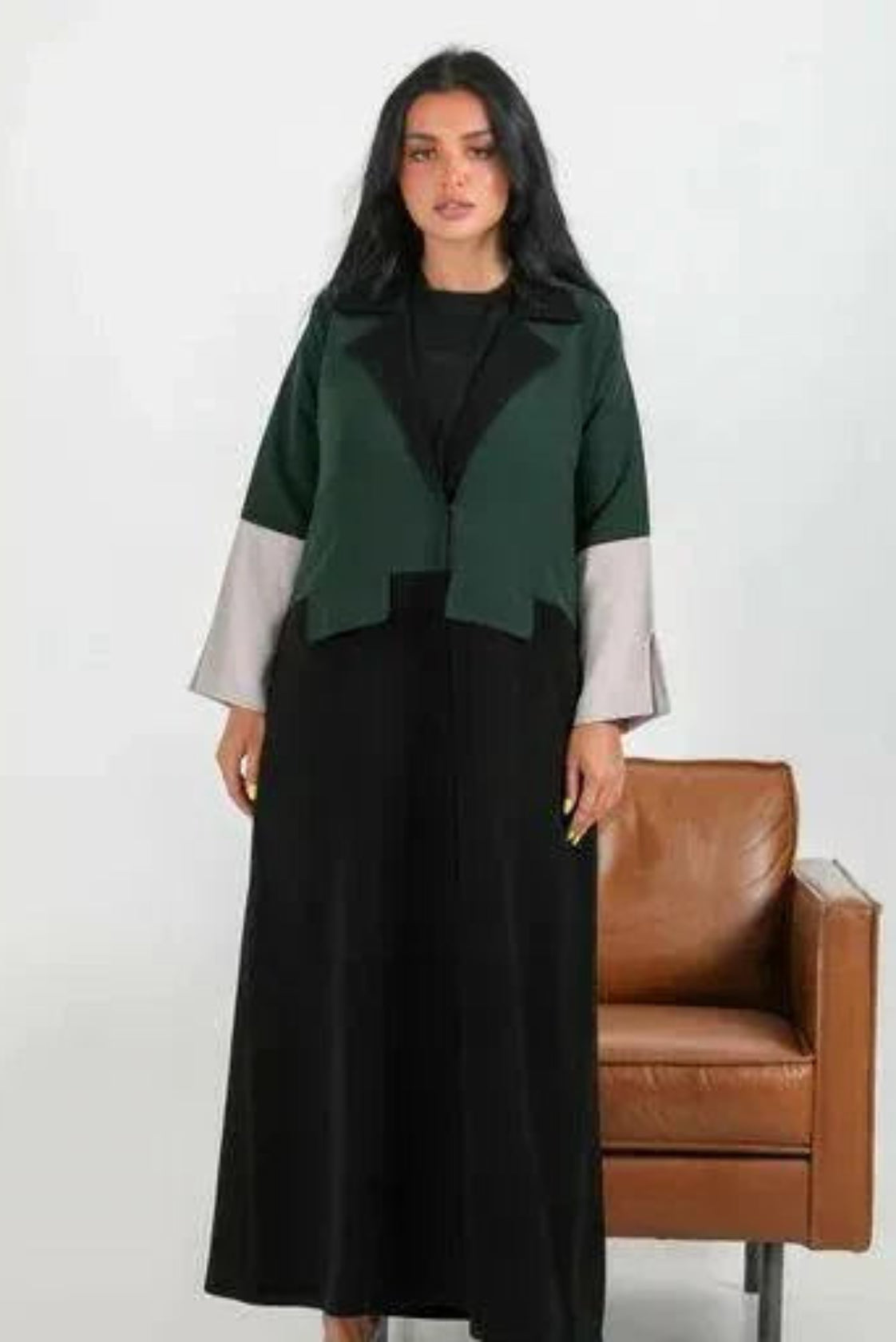 Color-blocked crepe blazer abaya with forest green body, black lapels, and grey sleeve cuffs over a flowy black base.