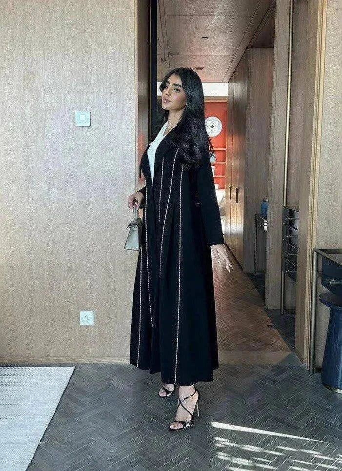 Modern black abaya with white line detailing in soft crepe fabric for everyday wear