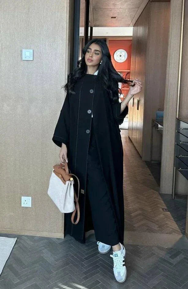 black abaya with button details and straight lines in soft crepe fabric, one-size breathable and modern design