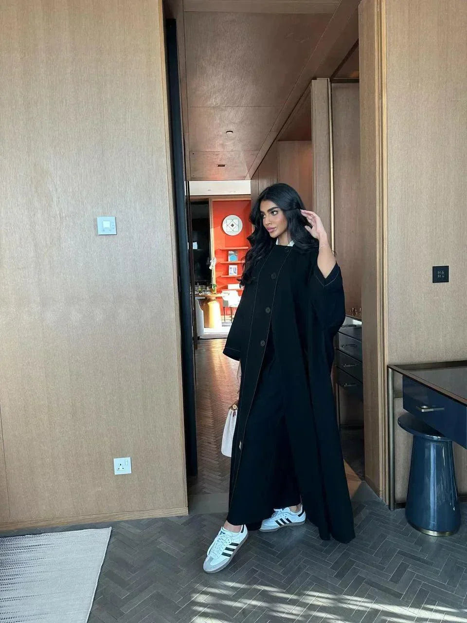 black abaya with button details and straight lines in soft crepe fabric, one-size breathable and modern design