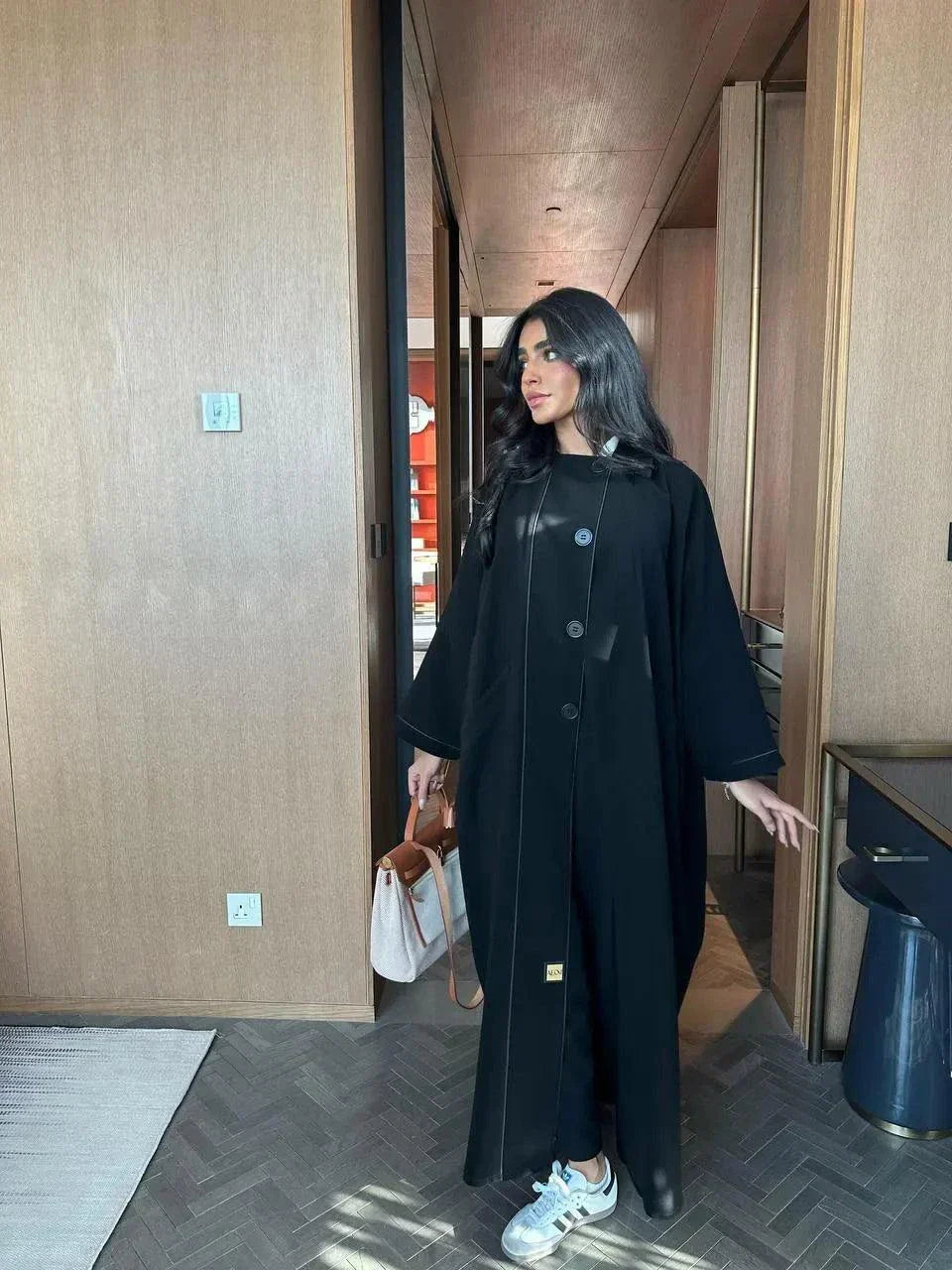 black abaya with button details and straight lines in soft crepe fabric, one-size breathable and modern design