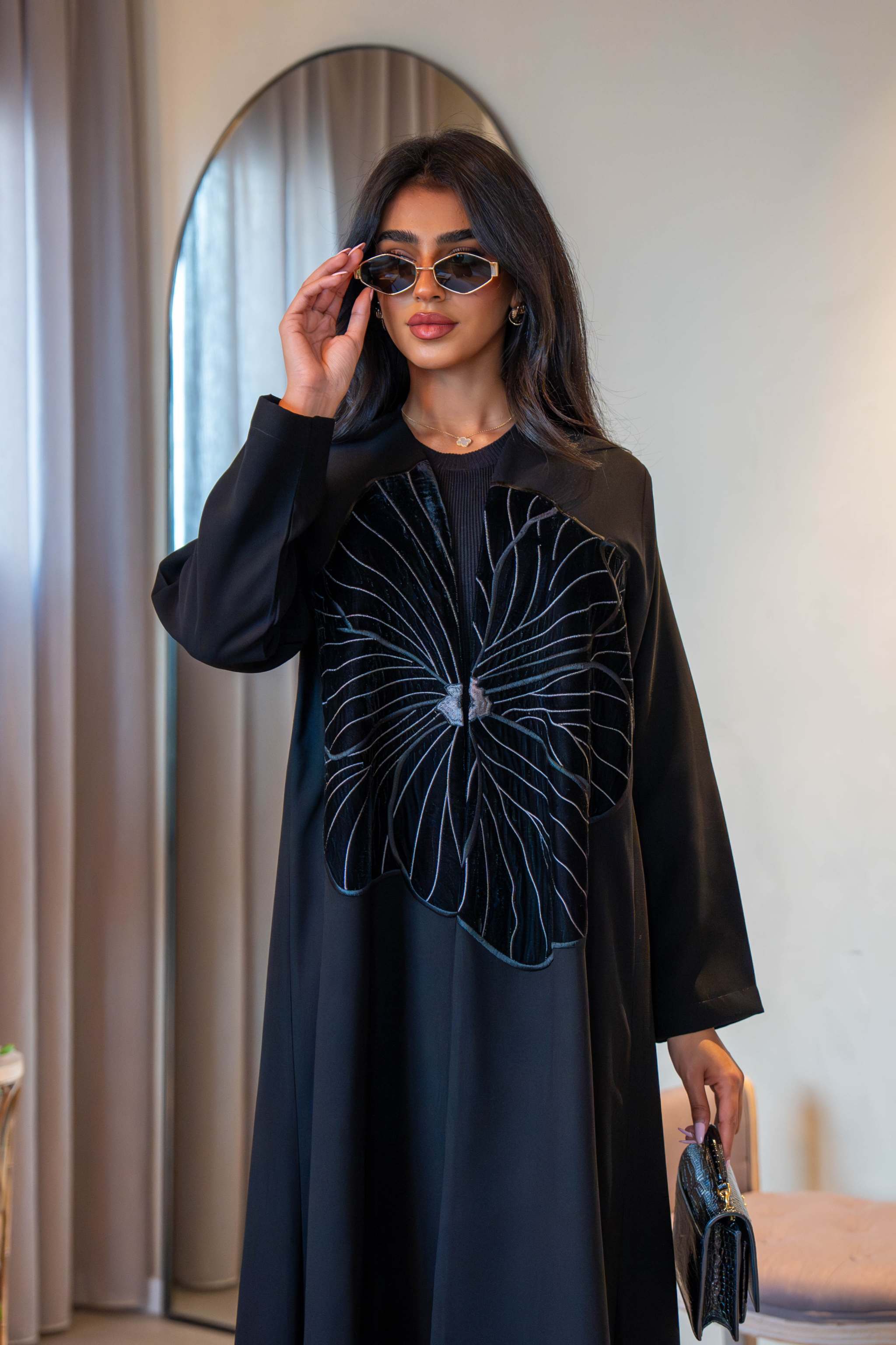 Classic black crepe abaya with velvet flower detail on front and simple silhouette