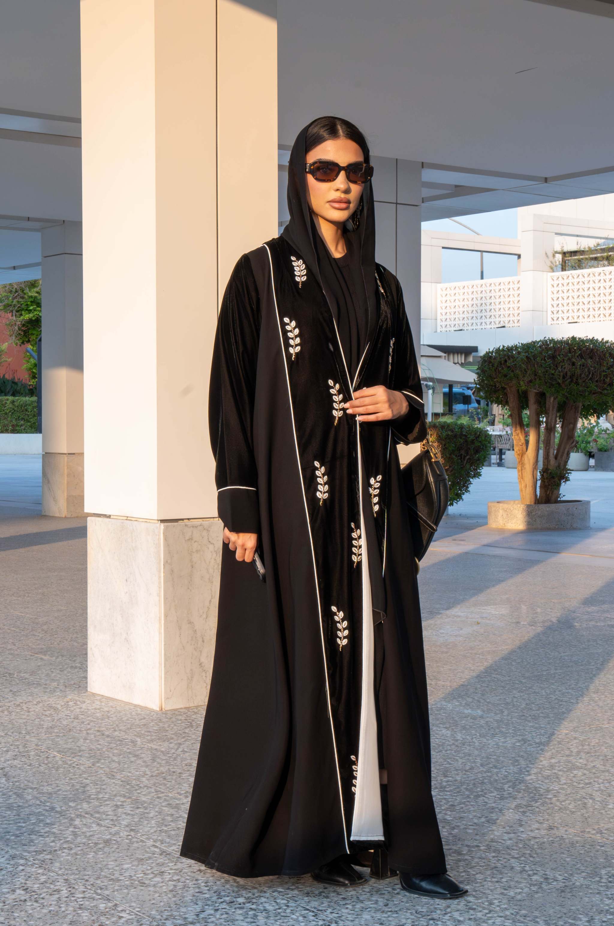 Elegant black Veloura Abaya with gold embroidery and velvet accents, perfect for special occasions.