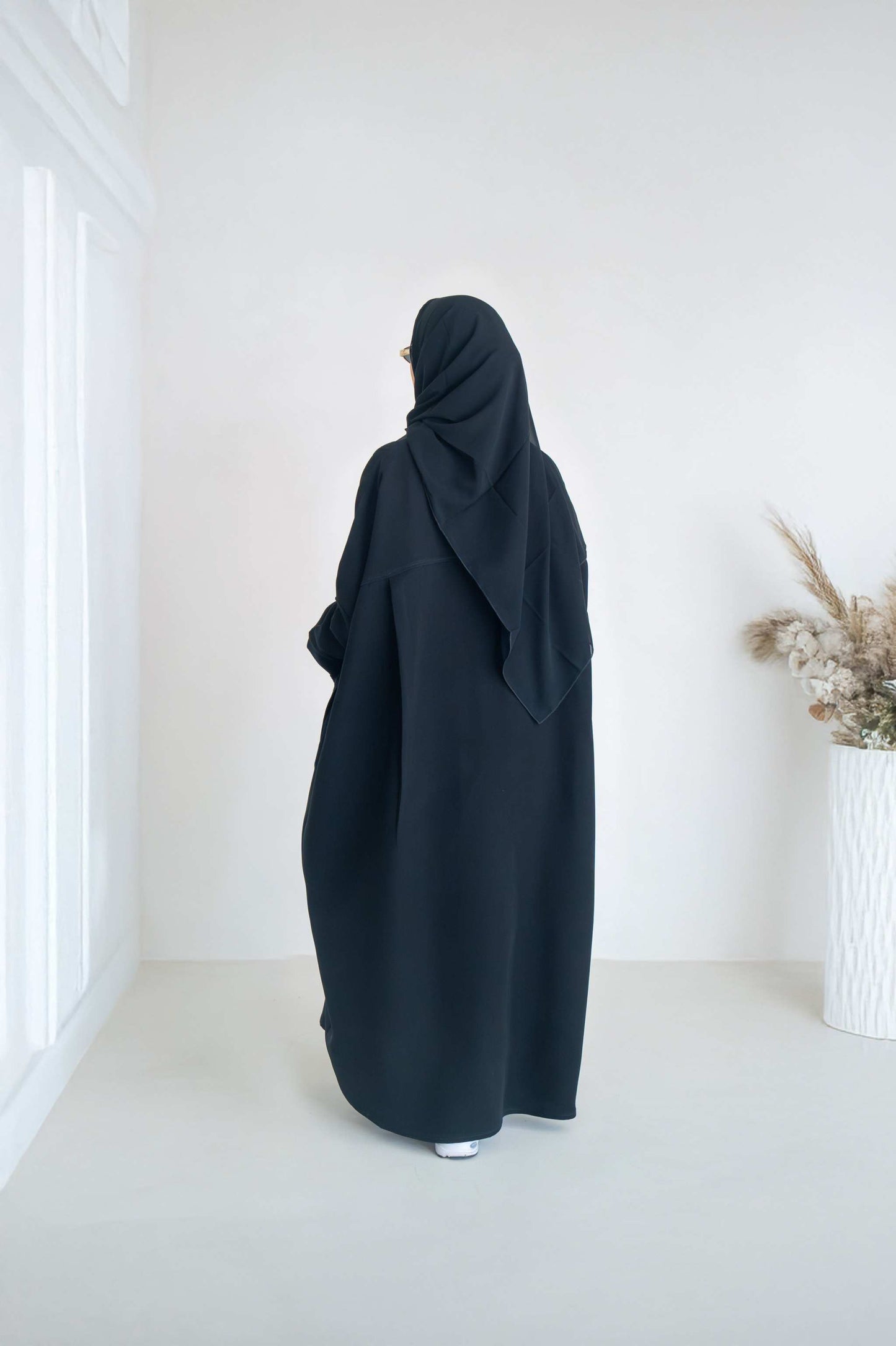 luxurious black crepe abaya with loose fit and elegant design for formal and everyday wear