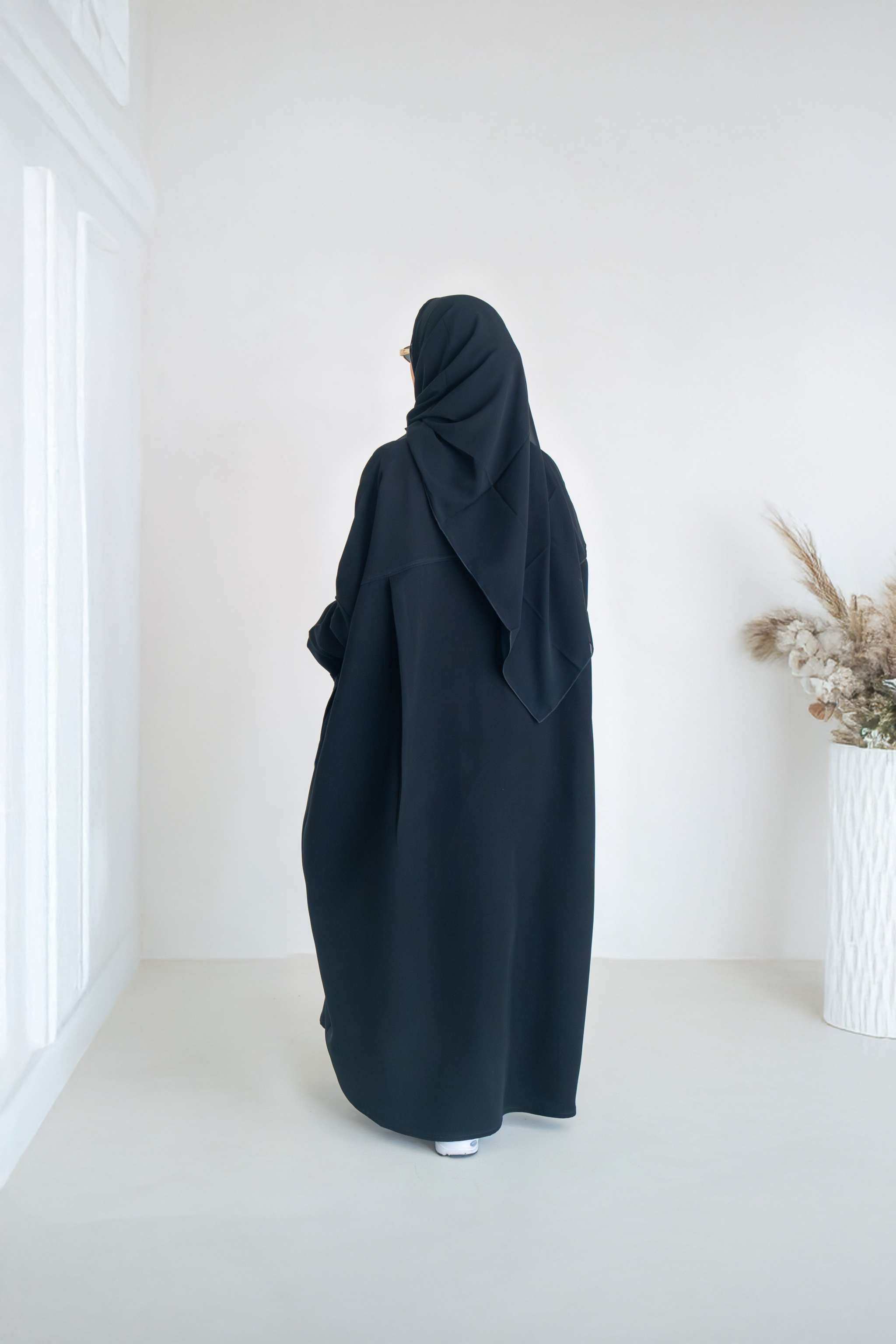 luxurious black crepe abaya with loose fit and elegant design for formal and everyday wear