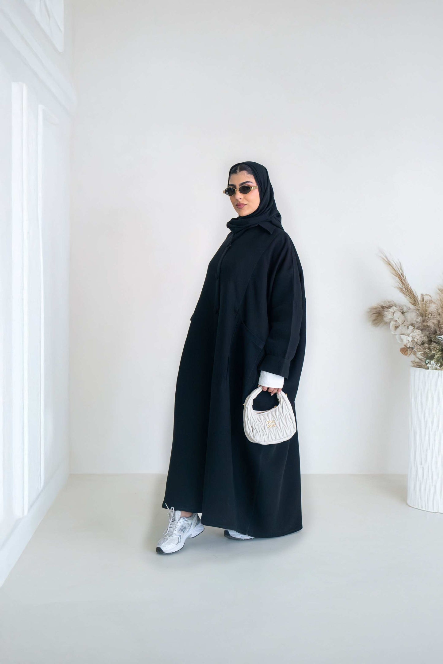 luxurious black crepe abaya with loose fit and elegant design for formal and everyday wear