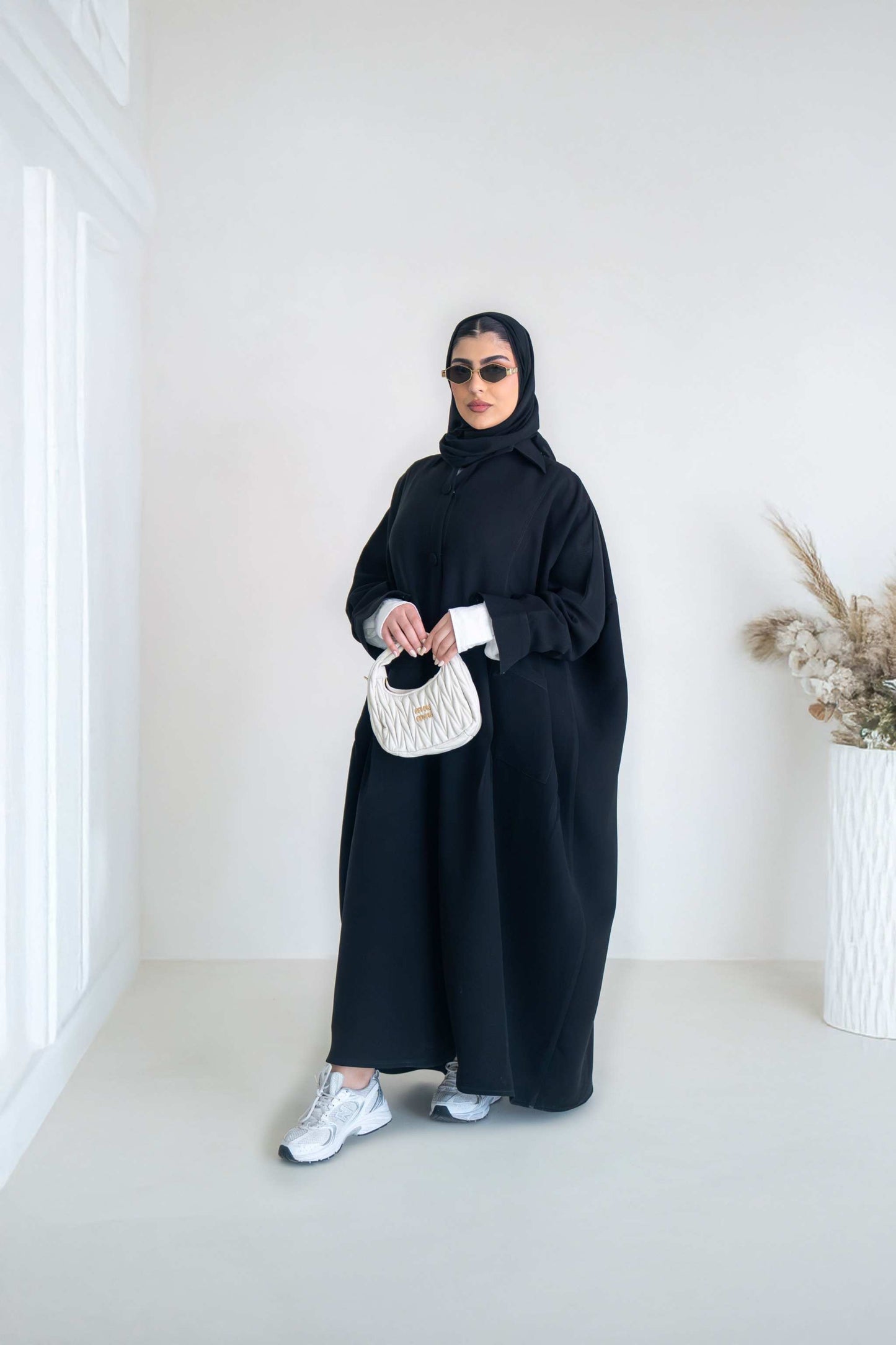 luxurious black crepe abaya with loose fit and elegant design for formal and everyday wear