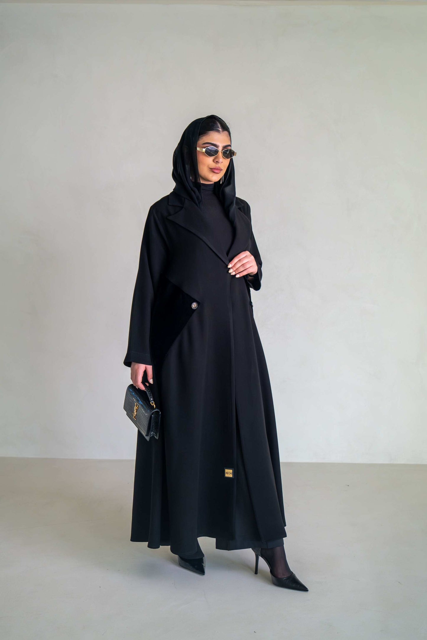 Elegant black abaya with velvet lapels and asymmetrical overlay, perfect for evening occasions