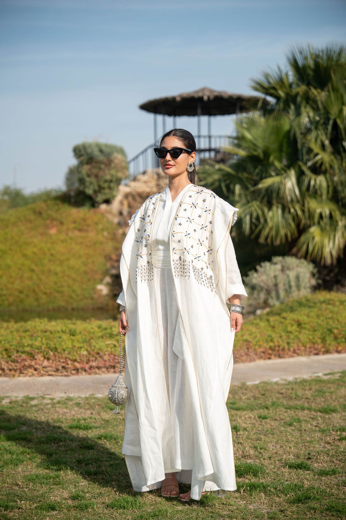Elegant white abaya with intricate hand embroidery and flowing fabric, perfect for special occasions and everyday wear