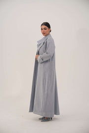 Lightweight bluish-gray blazer-style abaya with wide lapel and embellished cuffs featuring white beads and crystals.