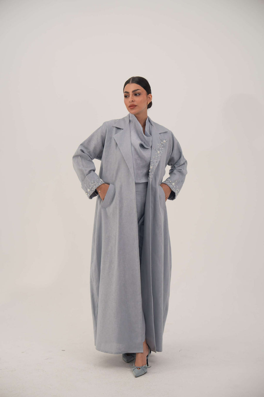 Lightweight blueish gray modern blazer-style abaya with open lapel and white bead and crystal embellishments on lapel and cuffs.