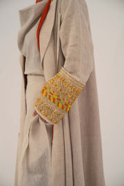 Beige linen abaya with orange, gold, and green shak embroidery on wide lapels and sleeves, featuring a vibrant orange chiffon lining - sophisticated abaya