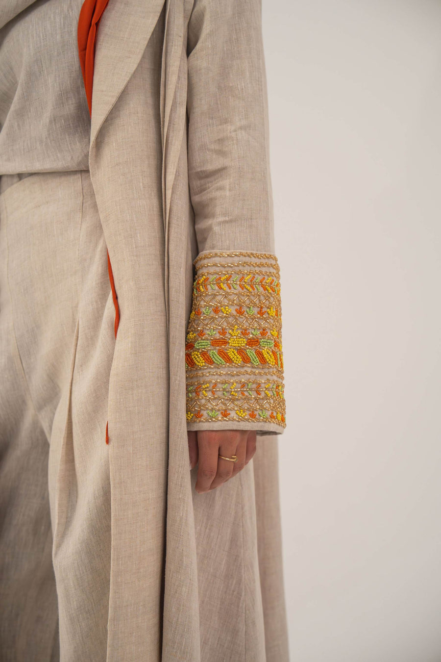 Beige linen blend abaya with tailored blazer cut and vibrant orange, gold, and green embroidery on sleeves - sophisticated abaya