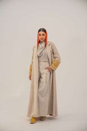 Beige linen blend abaya with tailored blazer cut, vibrant orange and gold embroidery on sleeves, and orange chiffon lining - sophisticated abaya