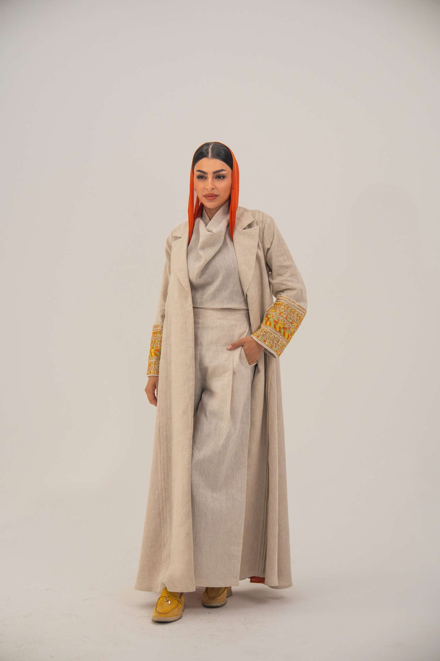 Beige linen blend abaya with tailored blazer cut, vibrant orange and gold embroidery on sleeves, and orange chiffon lining - sophisticated abaya