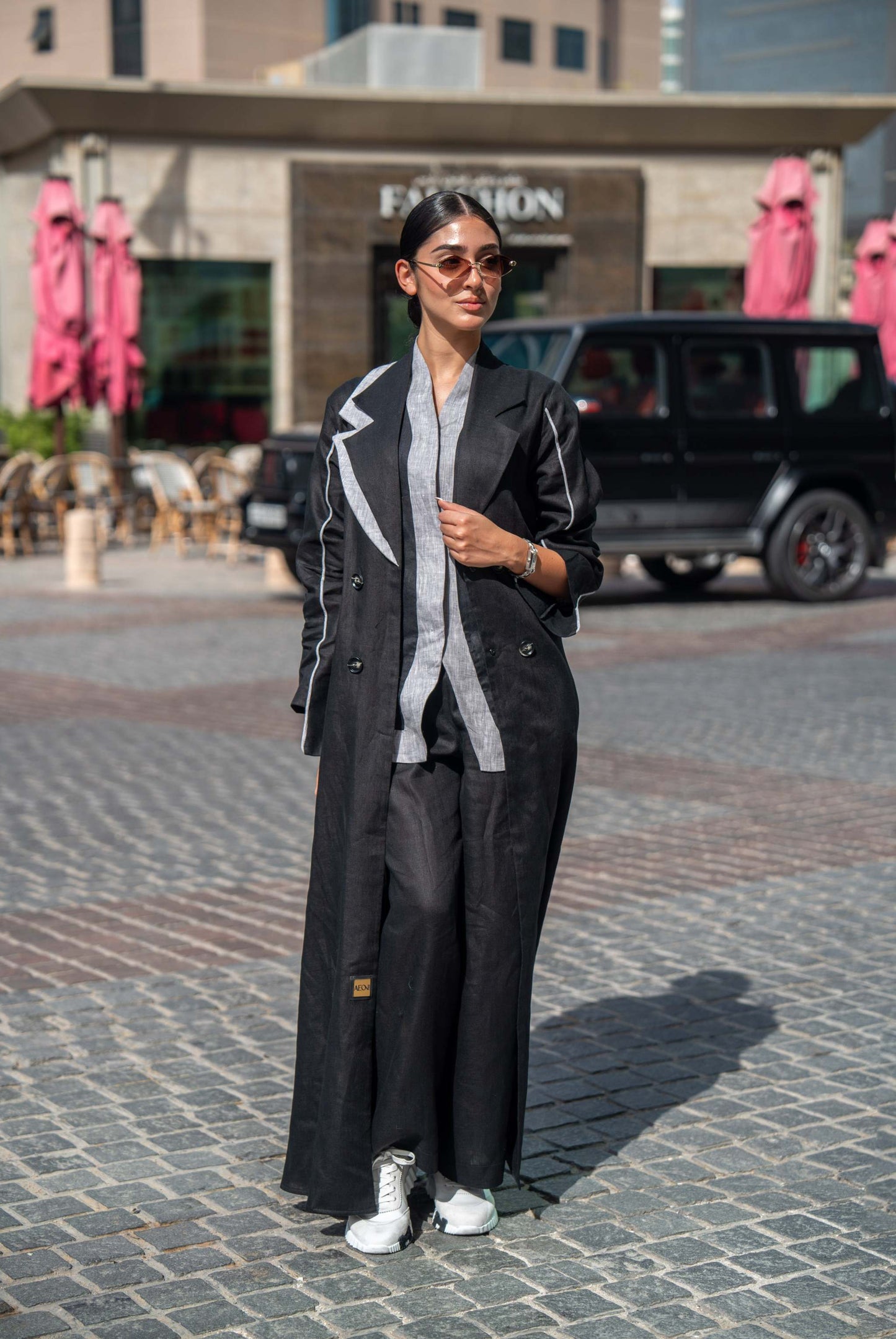 Black Blazer Abaya with sharp lapels and bold white piping, combining tailored sophistication with modern street style for professional and casual wear.
