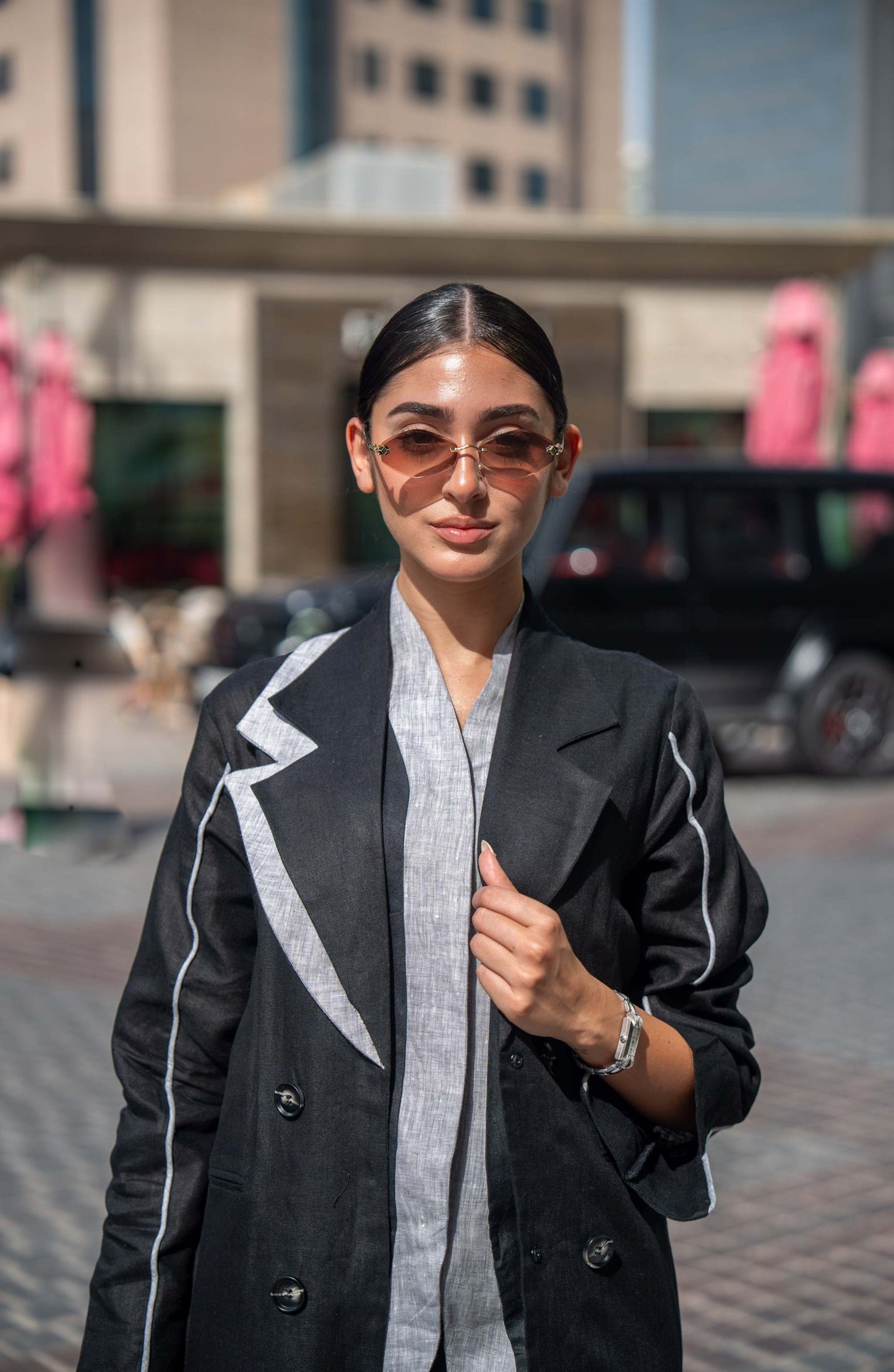 Black blazer abaya with sharp lapels and white piping, combining tailored sophistication with modern street style.