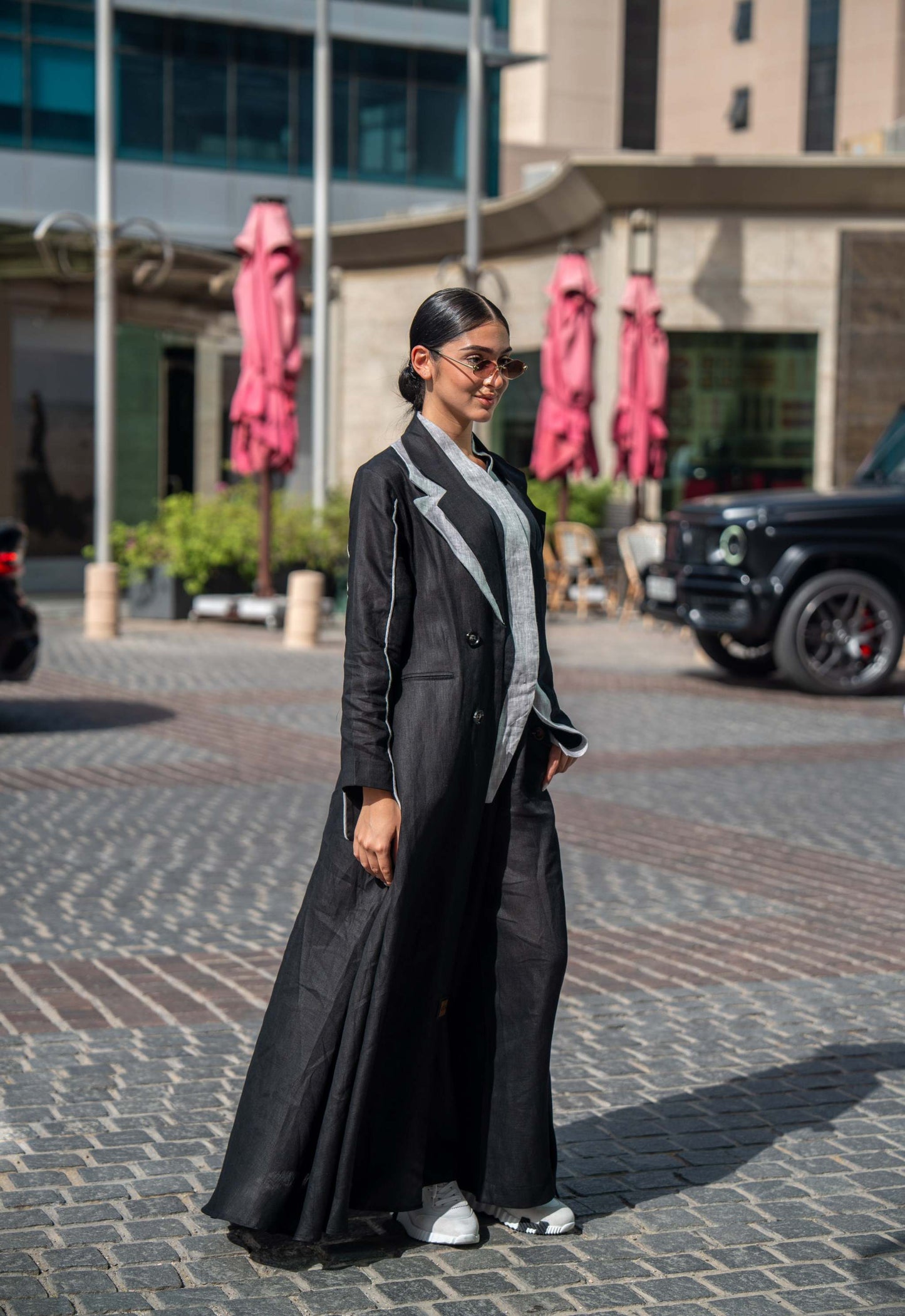 Black tailored blazer abaya with sharp lapels and white piping for a polished modern look