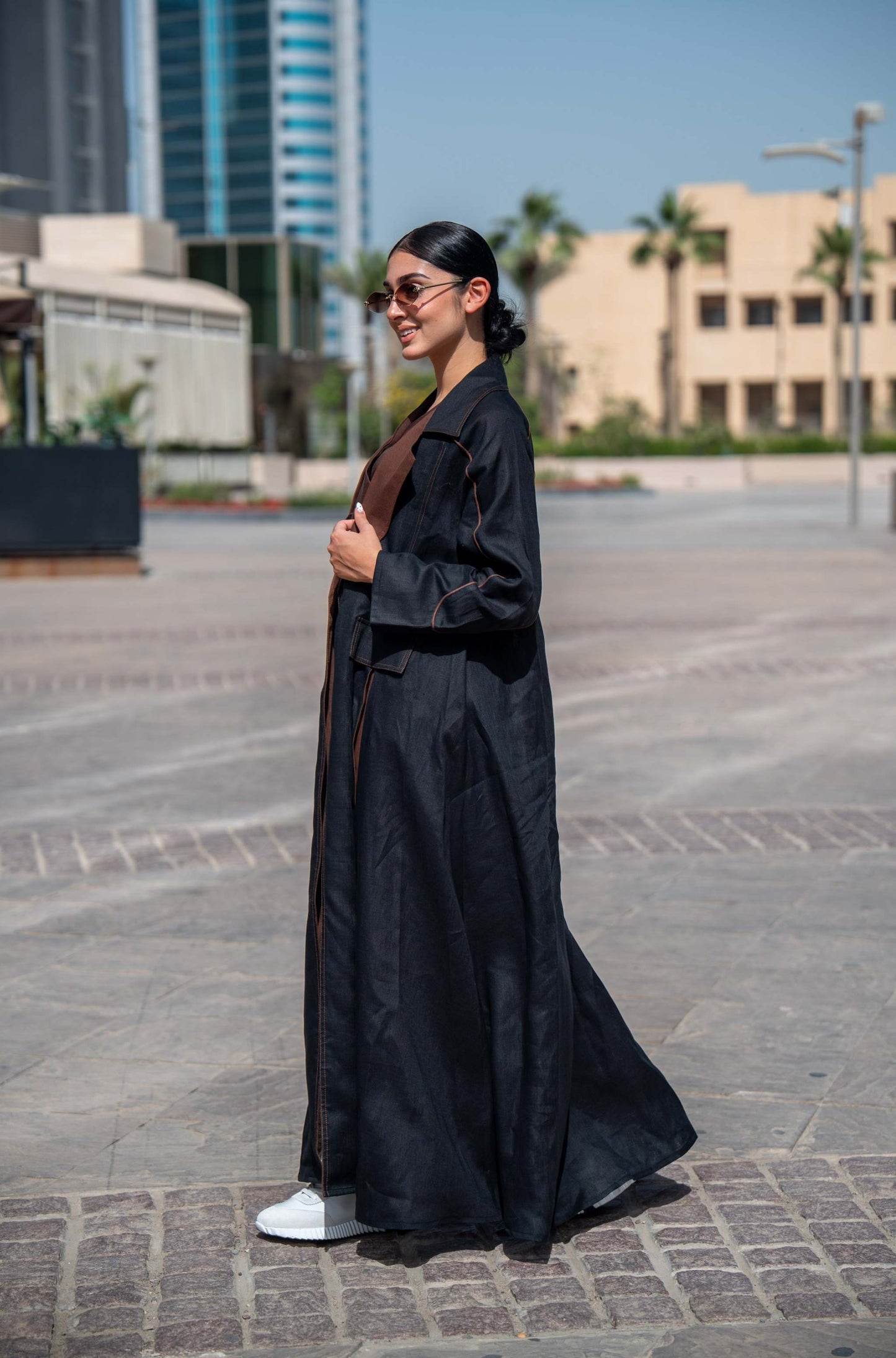 Modern black and brown linen abaya with wide lapels and structured street-style design