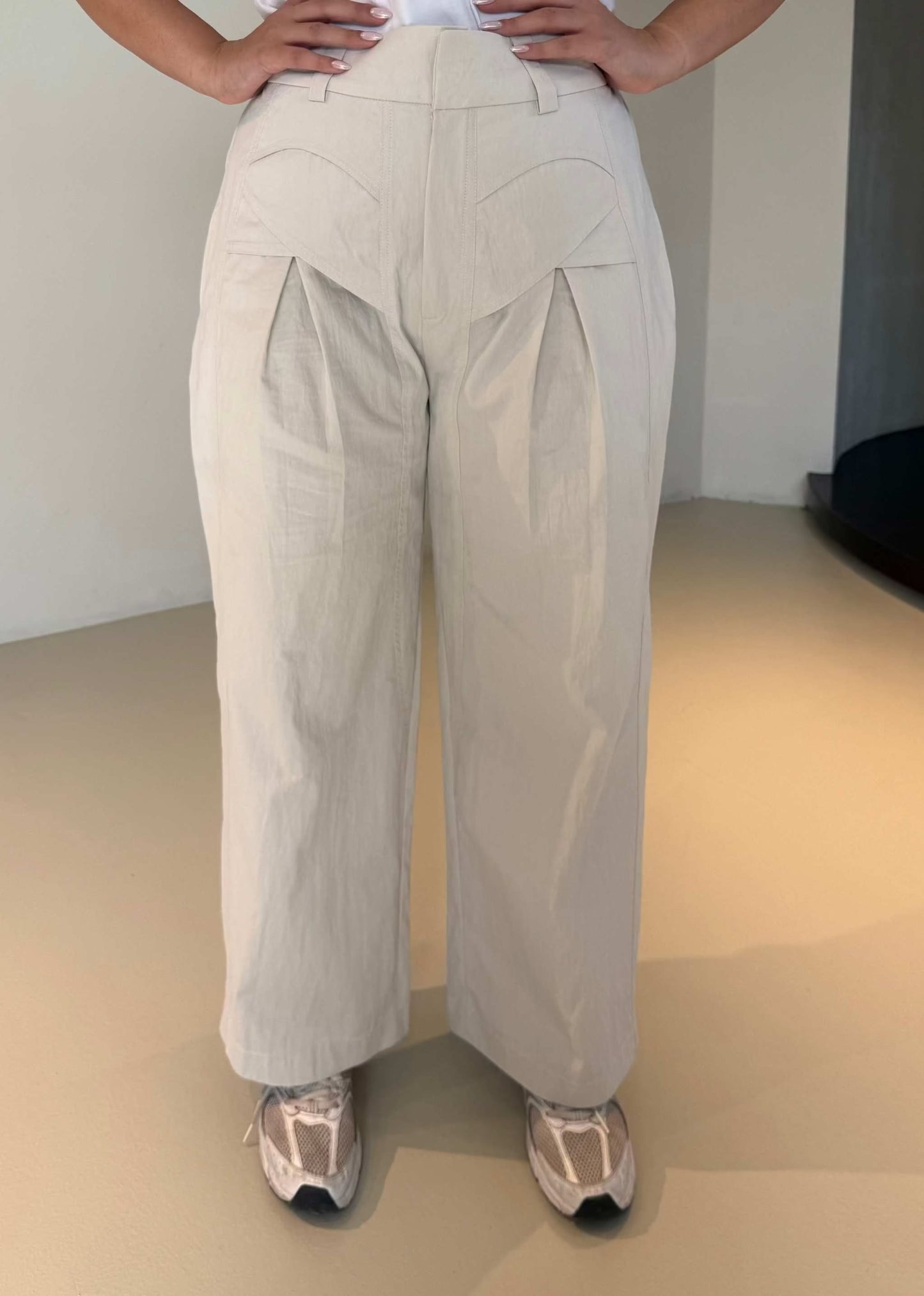 Light-colored wide-leg pleated crepe pants with a relaxed fit and elegant silhouette - The Elegant Pleated Crepe Pants