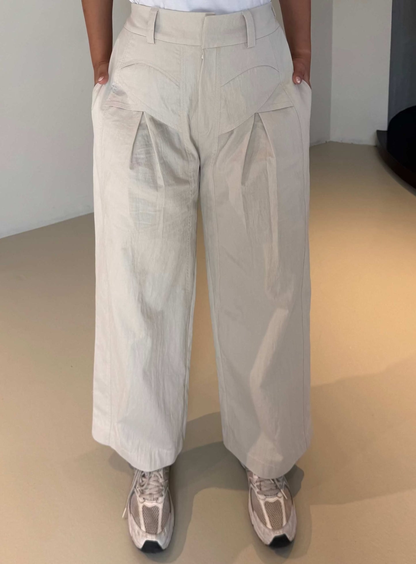 Light-colored wide-leg pleated crepe pants with a relaxed fit and elegant silhouette - The Elegant Pleated Crepe Pants
