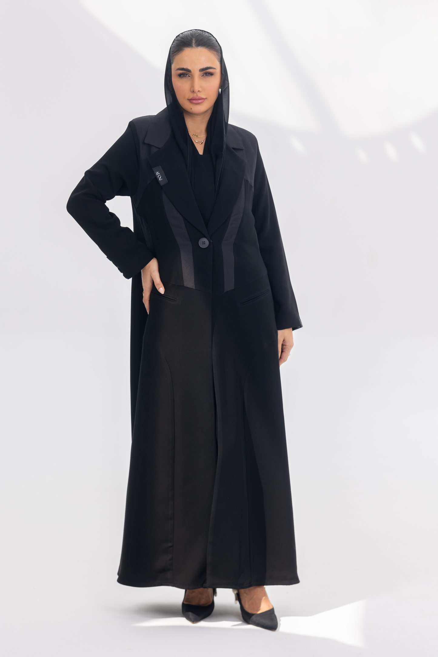 Jetline elegant black crepe abaya with dark grey accents and silk lining, front-open design for a sleek silhouette.