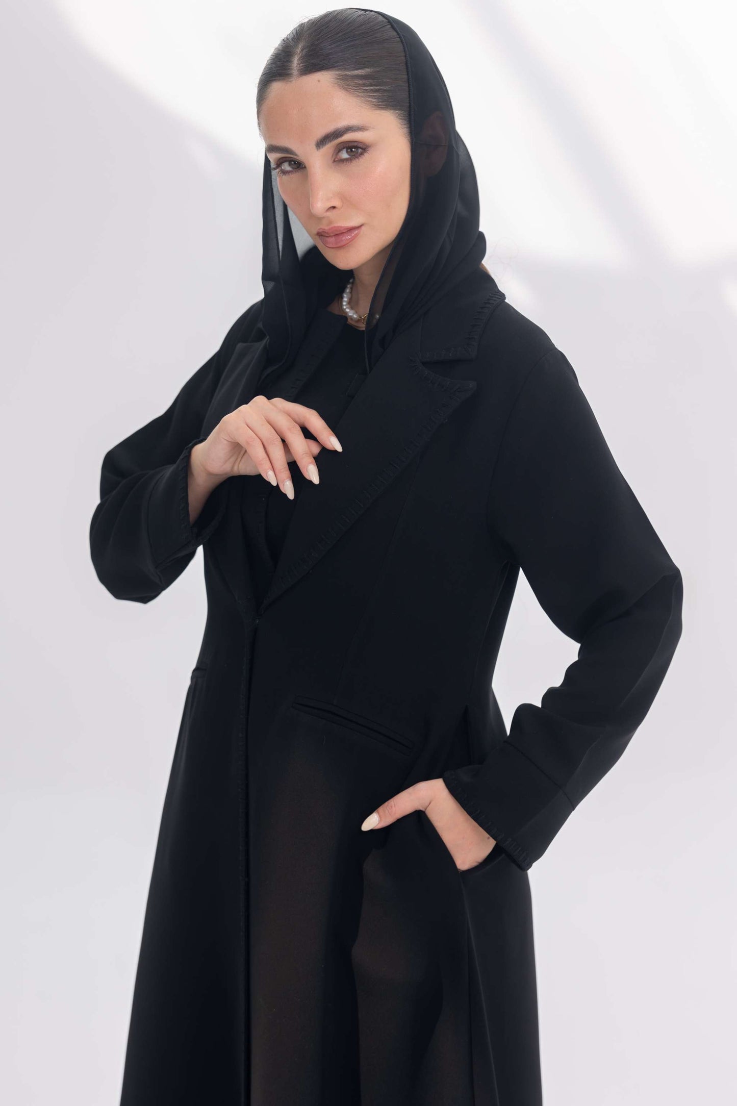 Black crepe blazer abaya with tailored silhouette and subtle embroidery, styled with matching black crepe inner and pants.