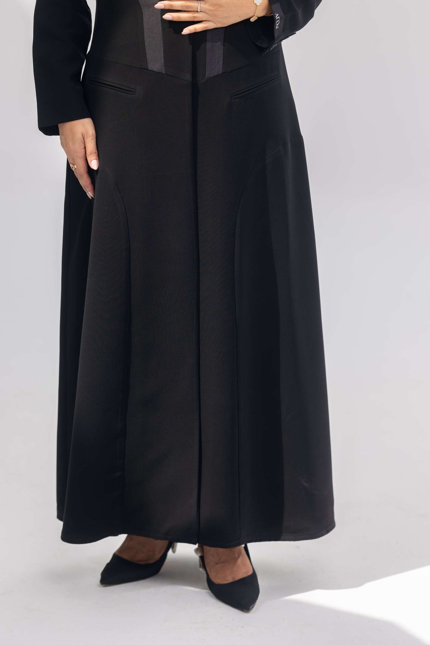 Elegant black crepe abaya with dark grey accents and silk lining, front-open and tailored for comfort and style