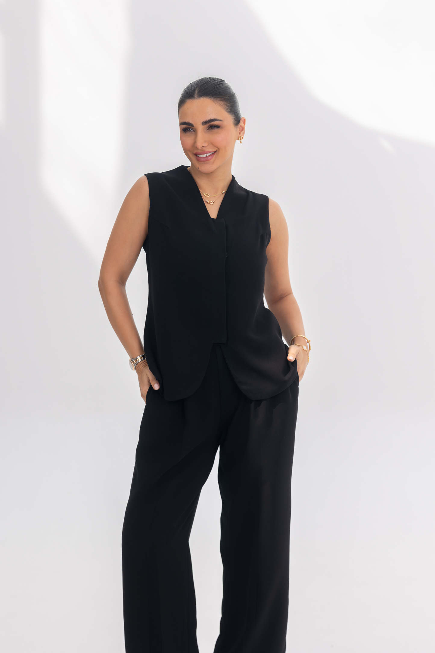 Woman wearing Noir Essential black sleeveless crepe inner set with fluid silhouette and minimalist design.