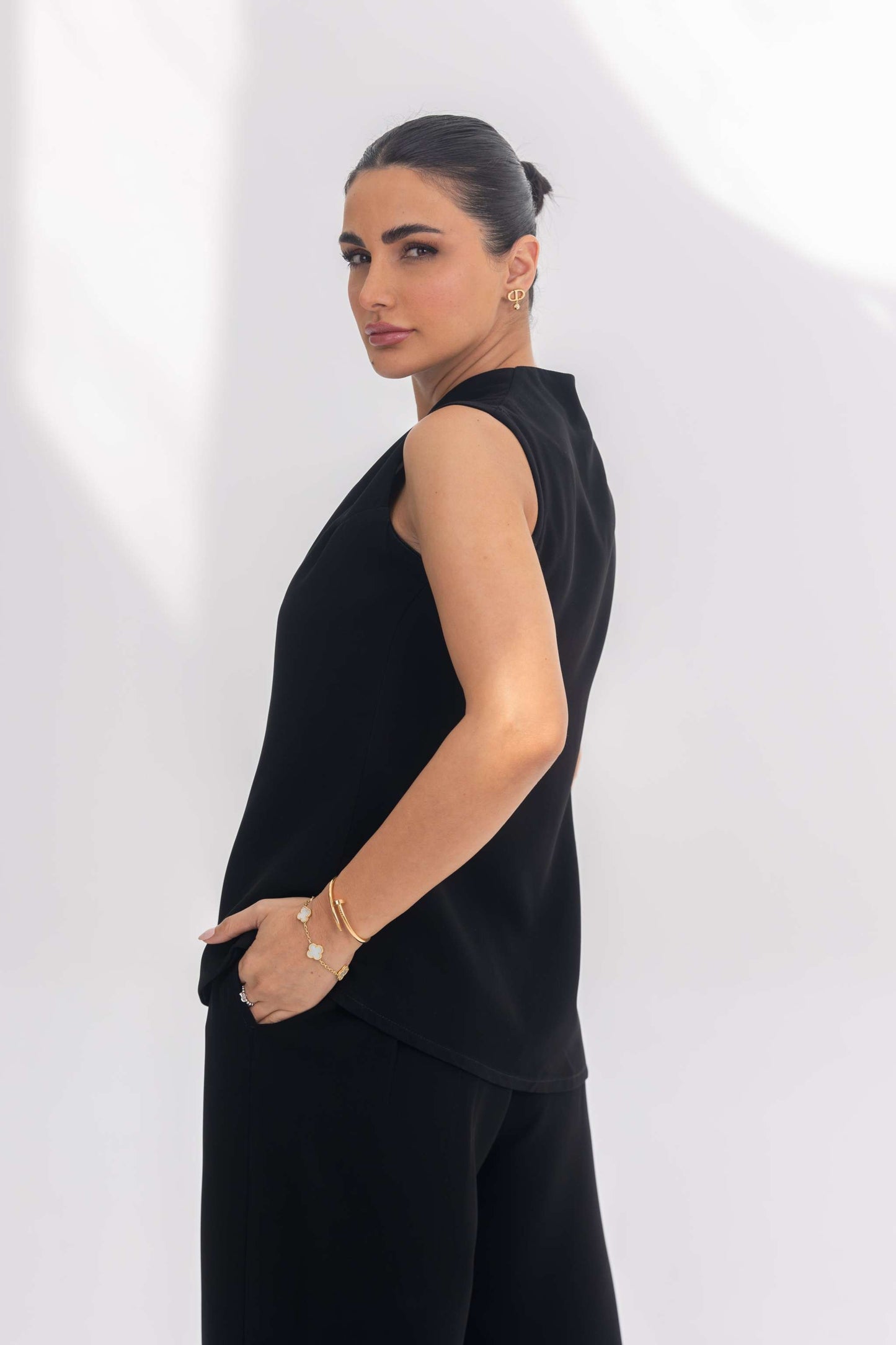 Woman wearing Noir Essential plain black crepe sleeveless inner set with minimalist design and elegant fit