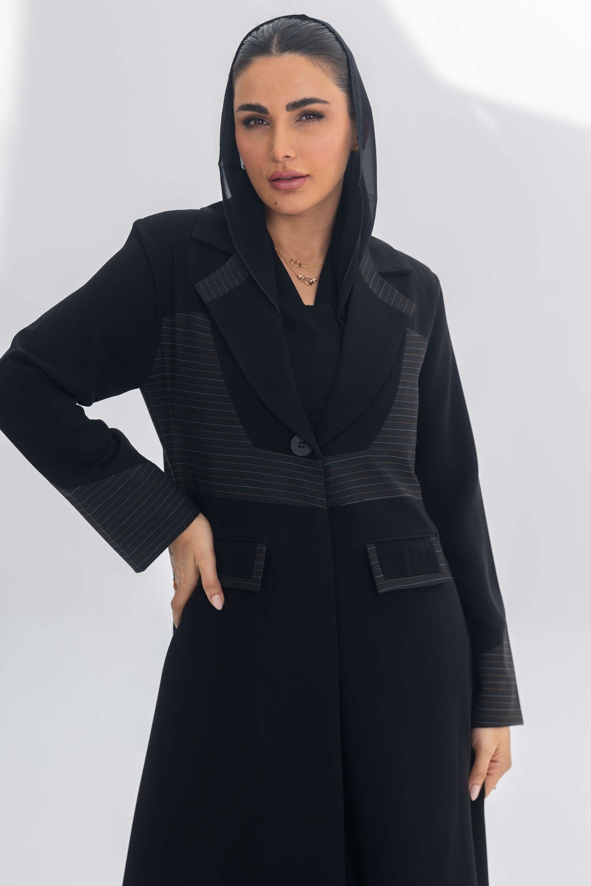 Woman wearing black crepe blazer abaya with contrasting textures and sleek tailored fit