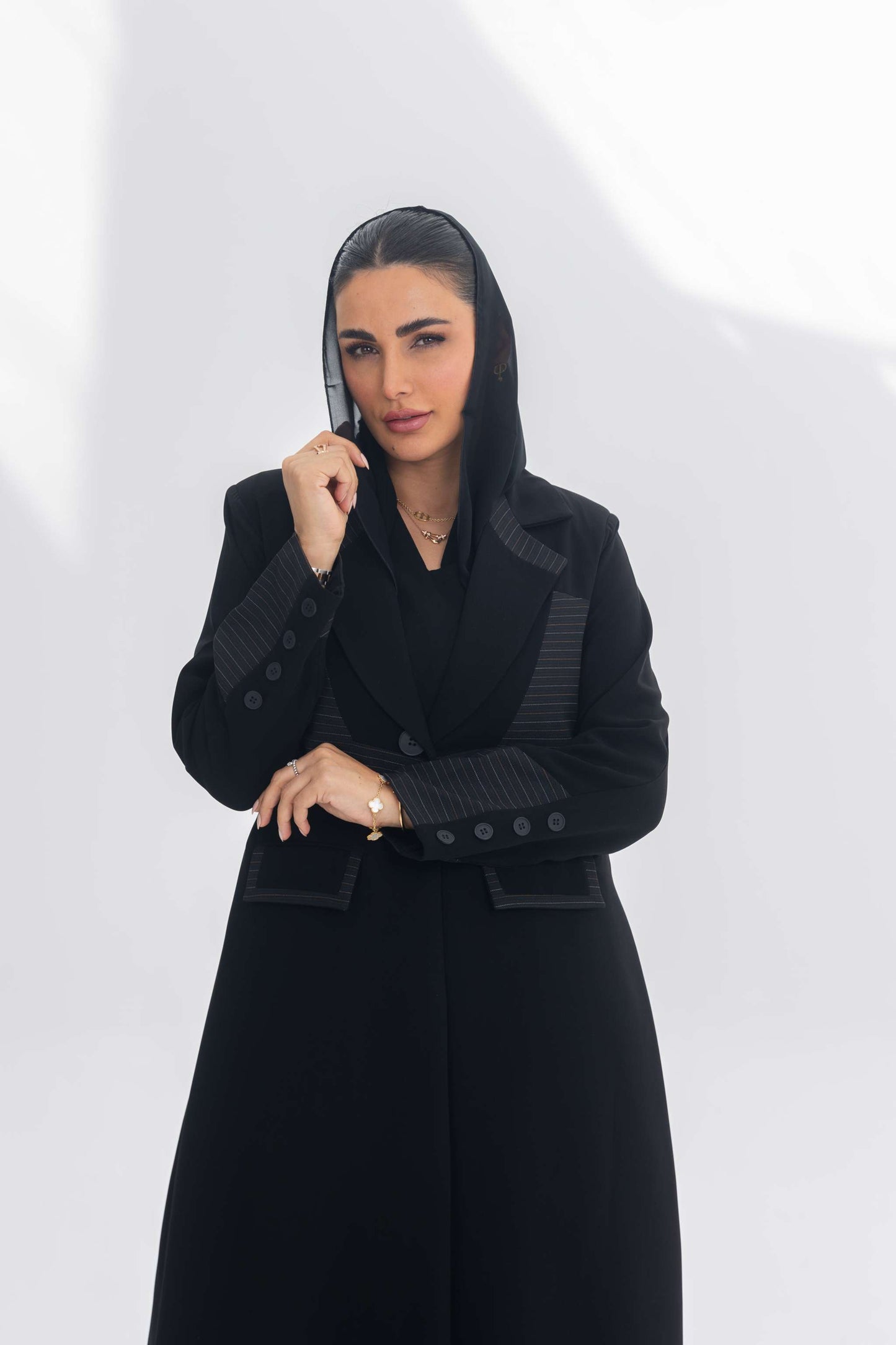 Woman wearing a black crepe blazer abaya with contrasting textured fabric, embodying modern elegance and sophistication.