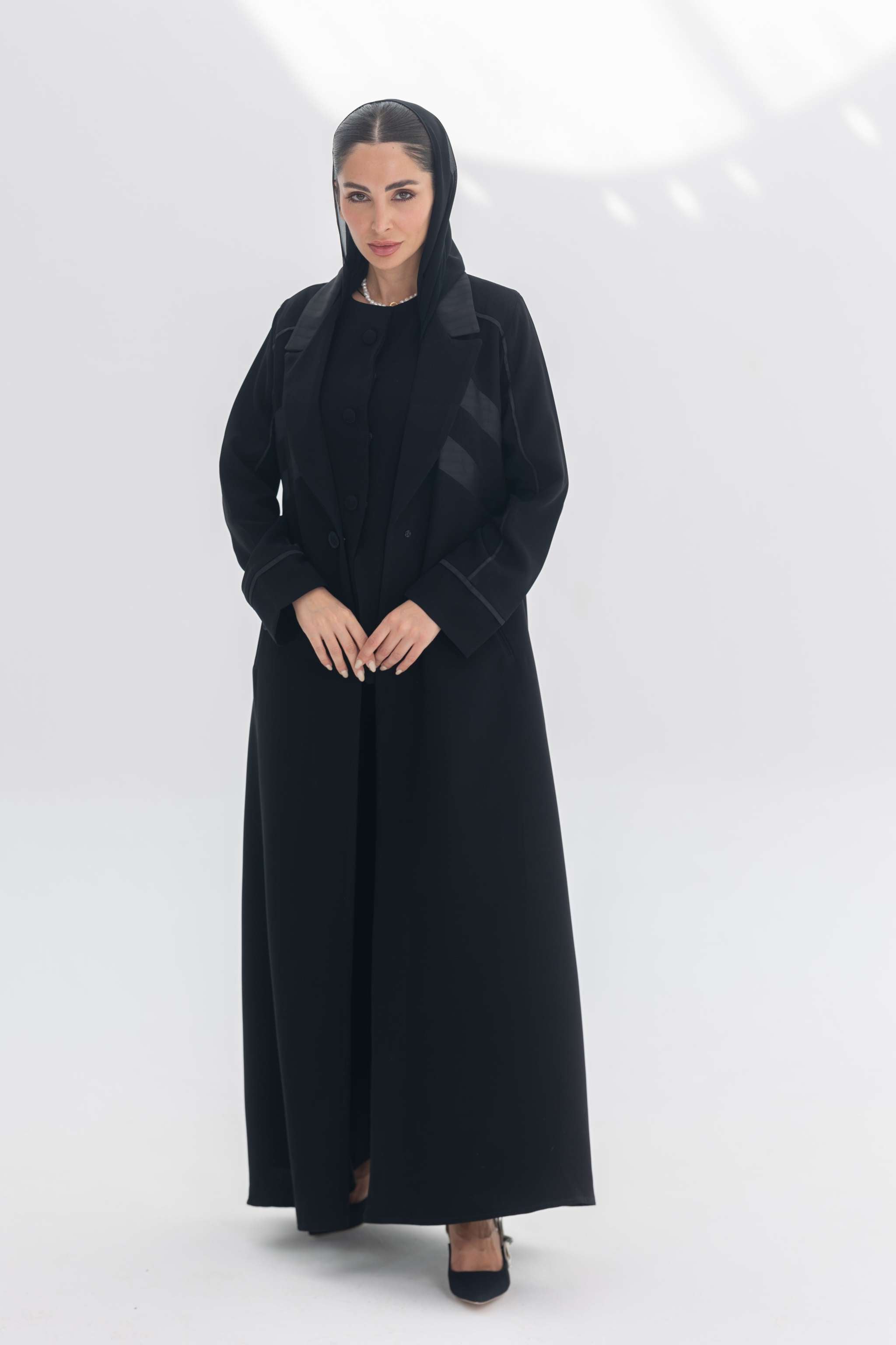 Noira Belle black crepe abaya with striped satin panels and modern design details for elegant style
