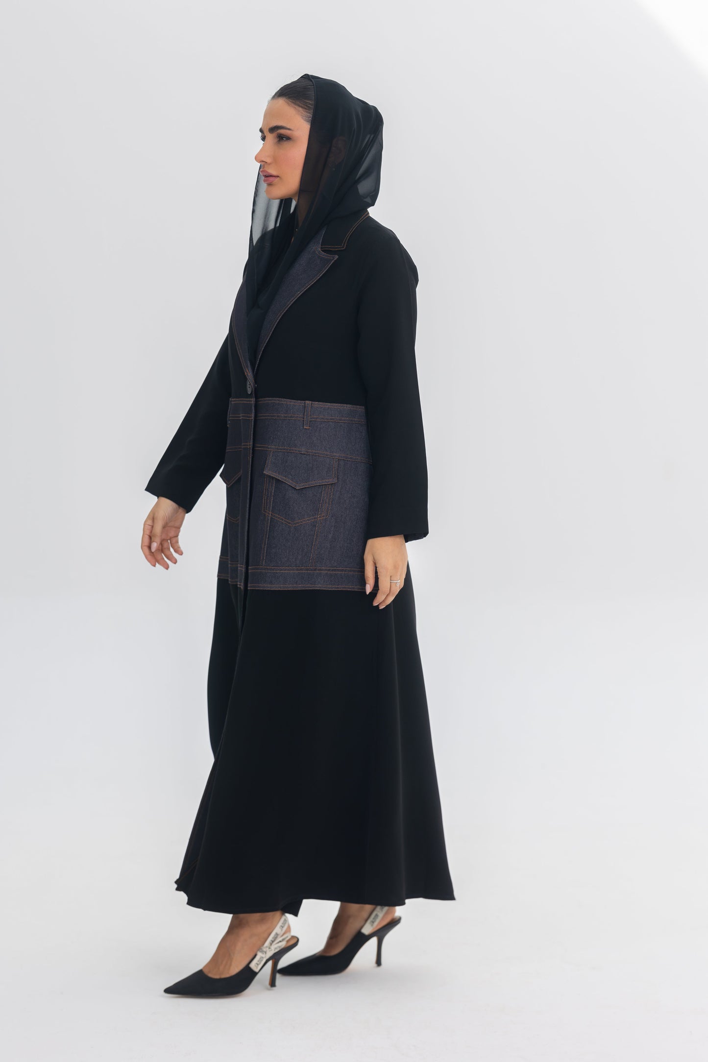 Modern black crepe abaya with blue denim stitch detailing and hooded design