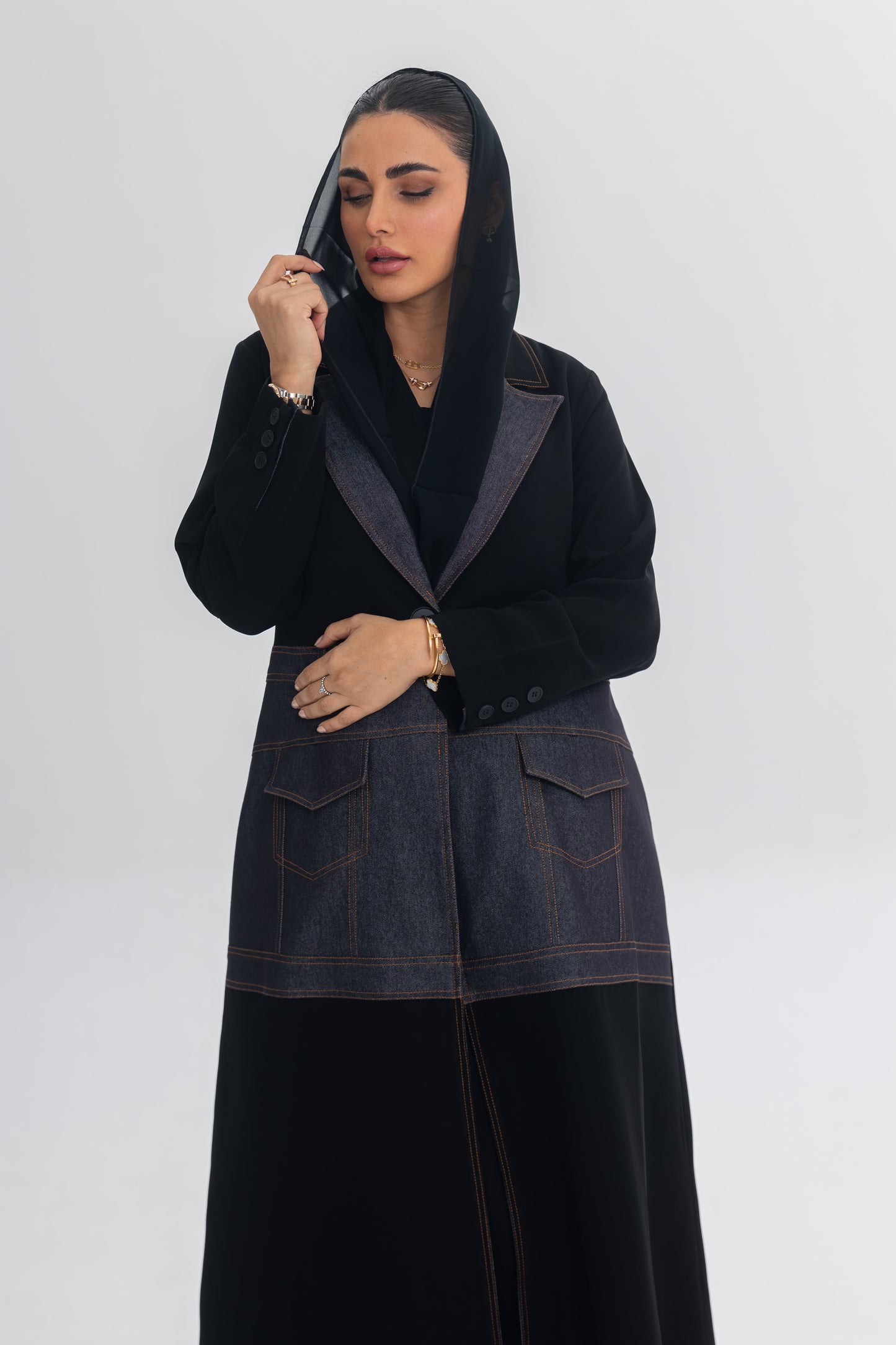 Woman wearing Blue Stitch black crepe and denim fusion abaya with modern, chic design