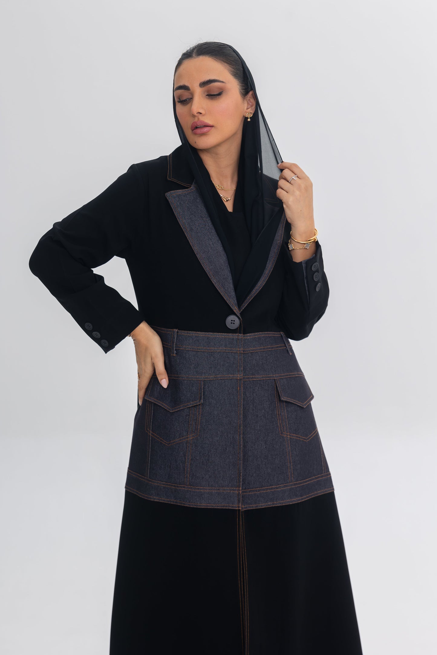 Woman wearing Blue Stitch abaya with black crepe and denim fabric fusion design