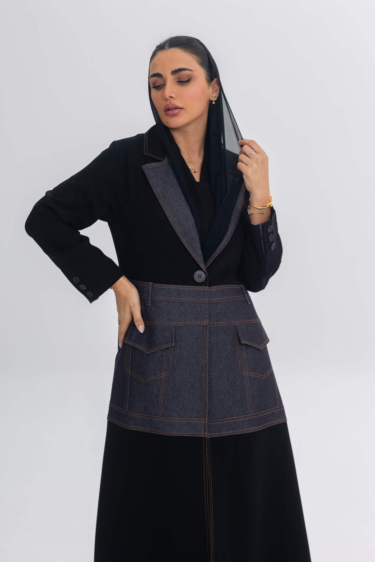 Woman wearing Blue Stitch abaya with black crepe and denim fabric fusion design