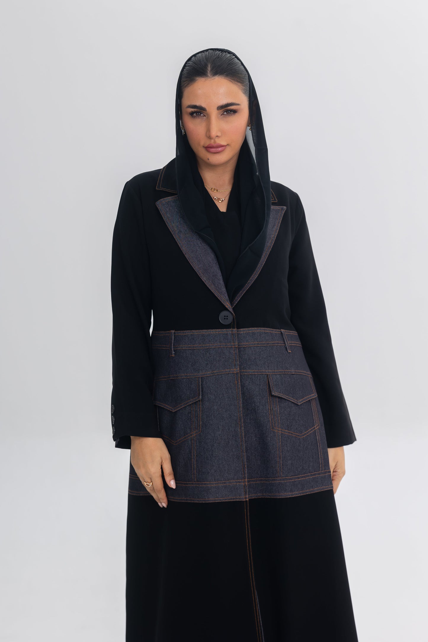 Woman wearing Blue Stitch black crepe and denim fusion abaya with modern, chic design