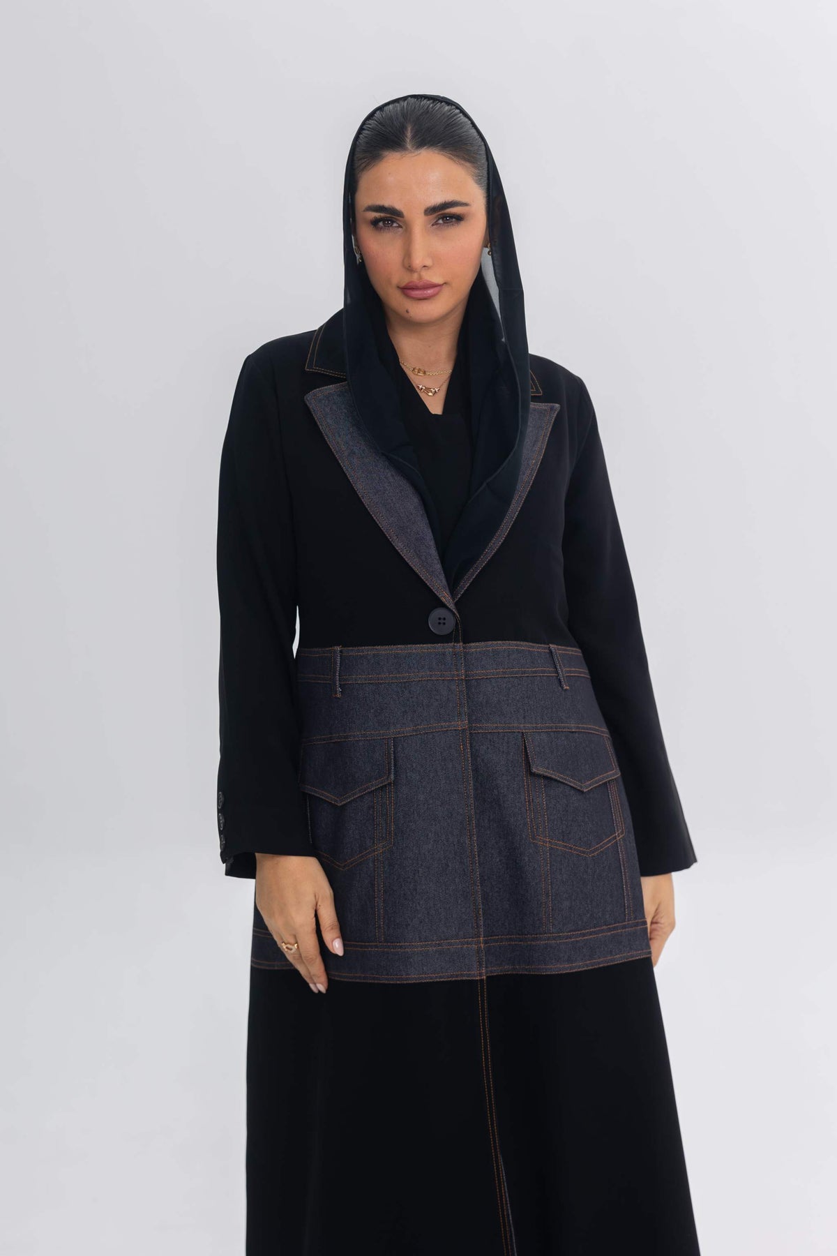Woman wearing Blue Stitch black crepe and denim fusion abaya with modern, chic design