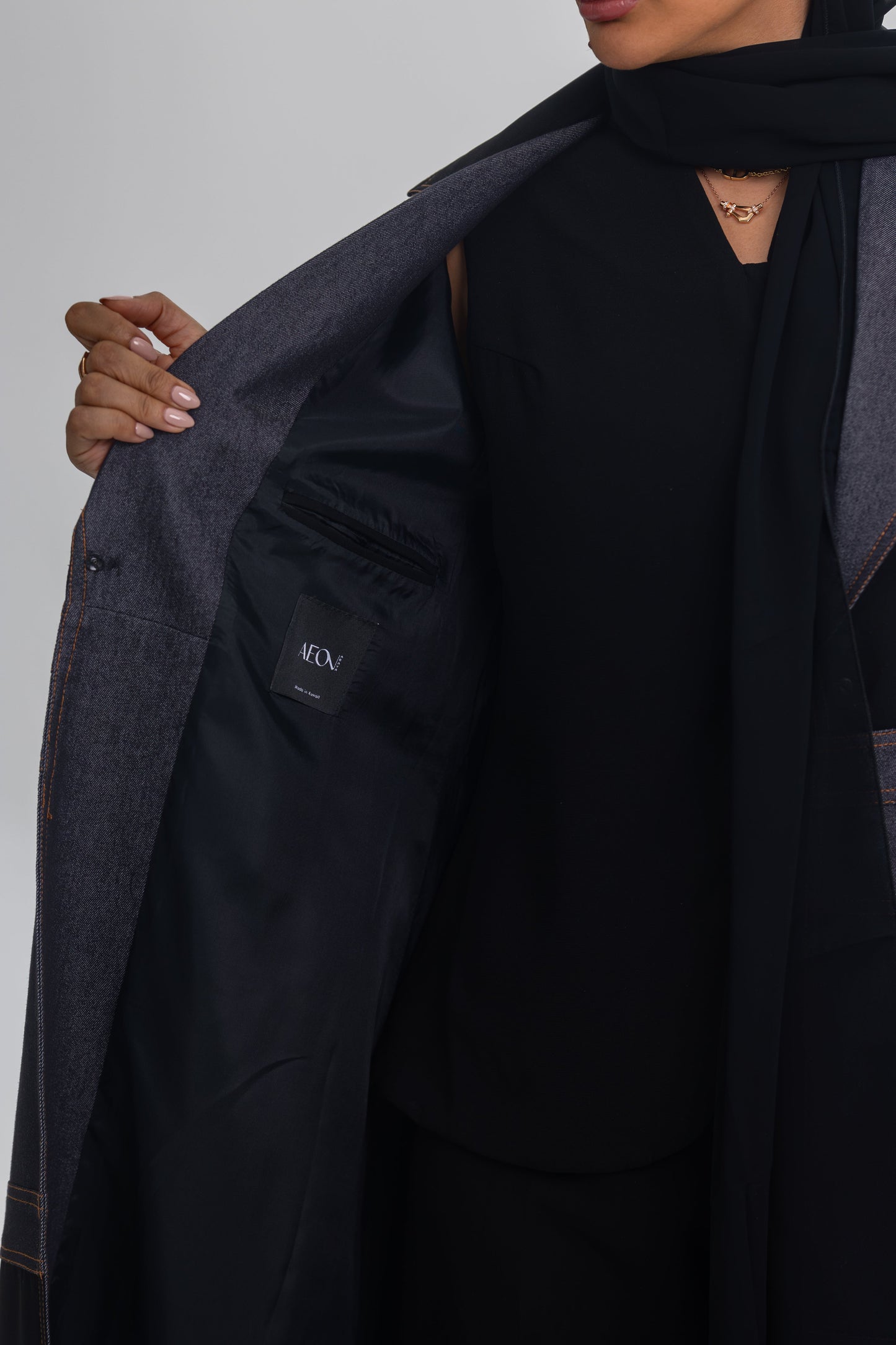Black crepe abaya with denim fabric detail showcasing Blue Stitch design and modern elegance