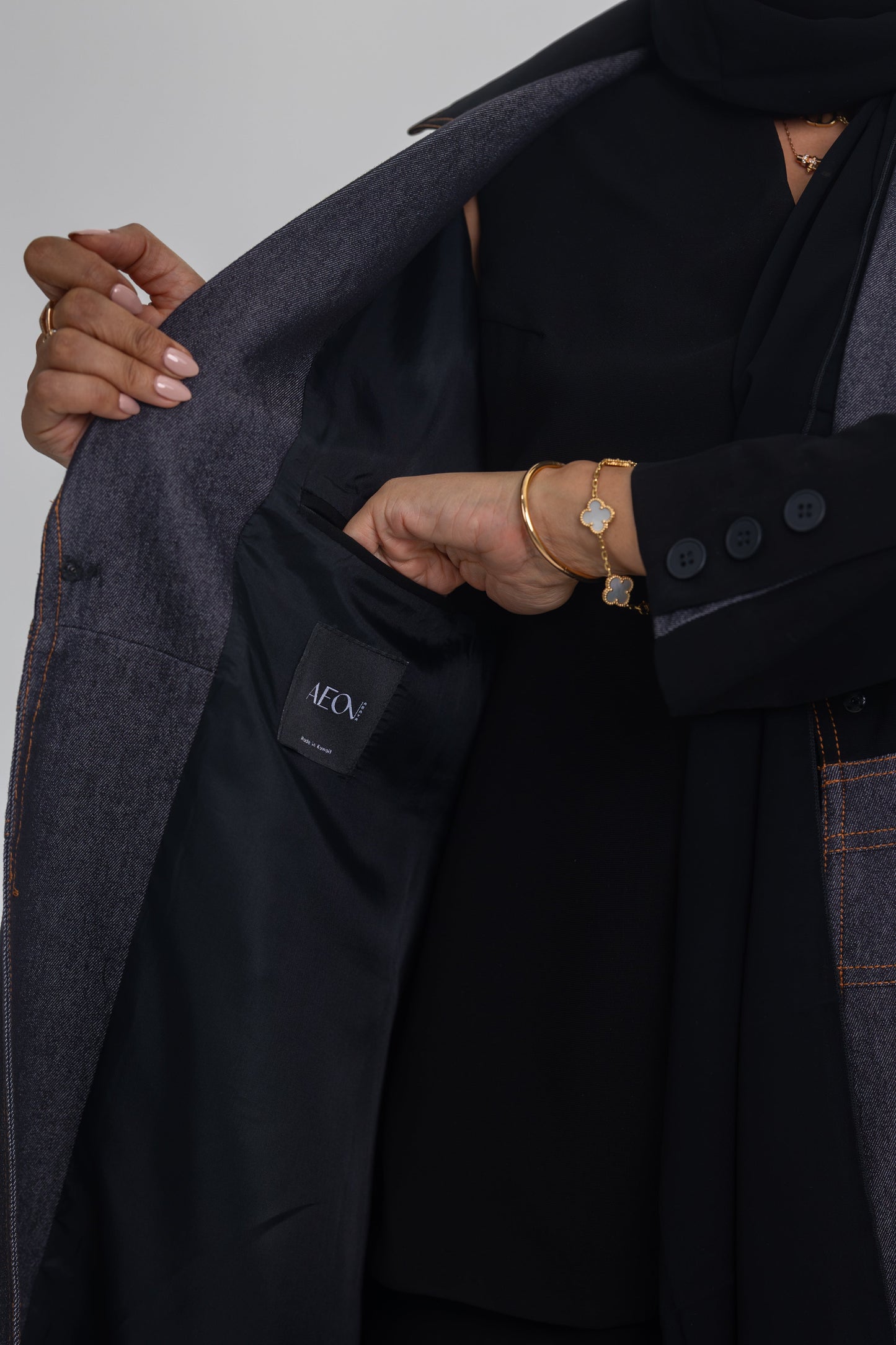 Blue Stitch abaya featuring black crepe and denim fabric fusion for modern elegance